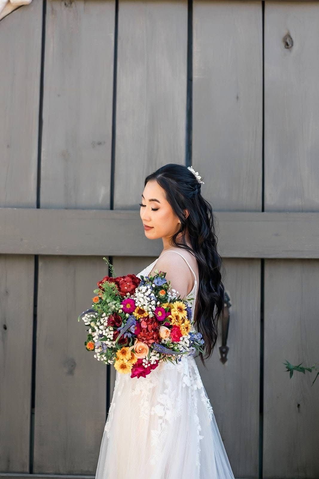 Bride with a half-up style and a colorful bouquet