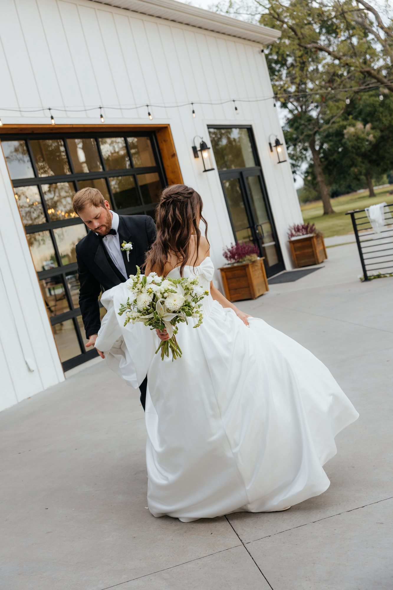Bride by a window in a lace gown
