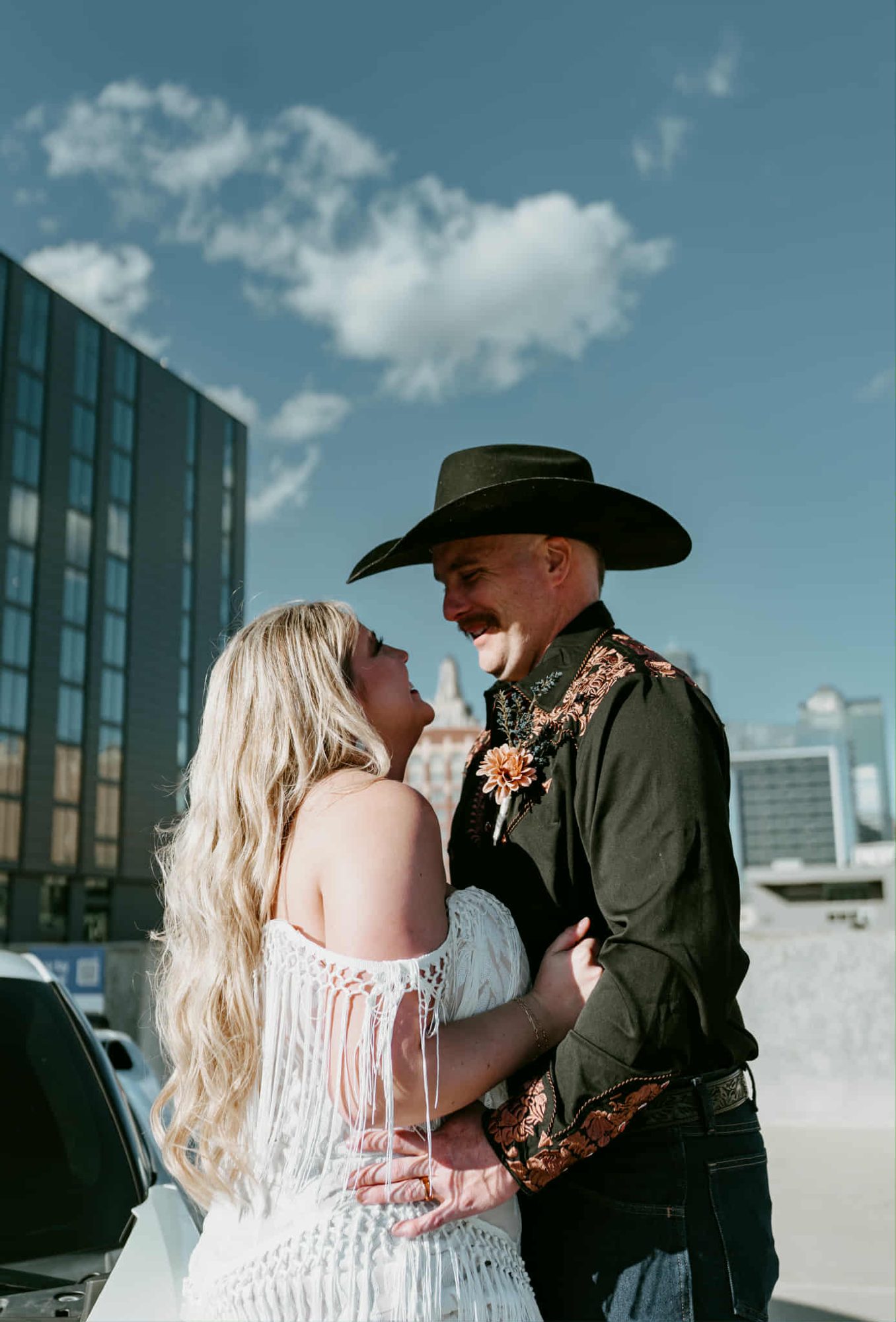 Couple kissing outdoors, bride with styled waves