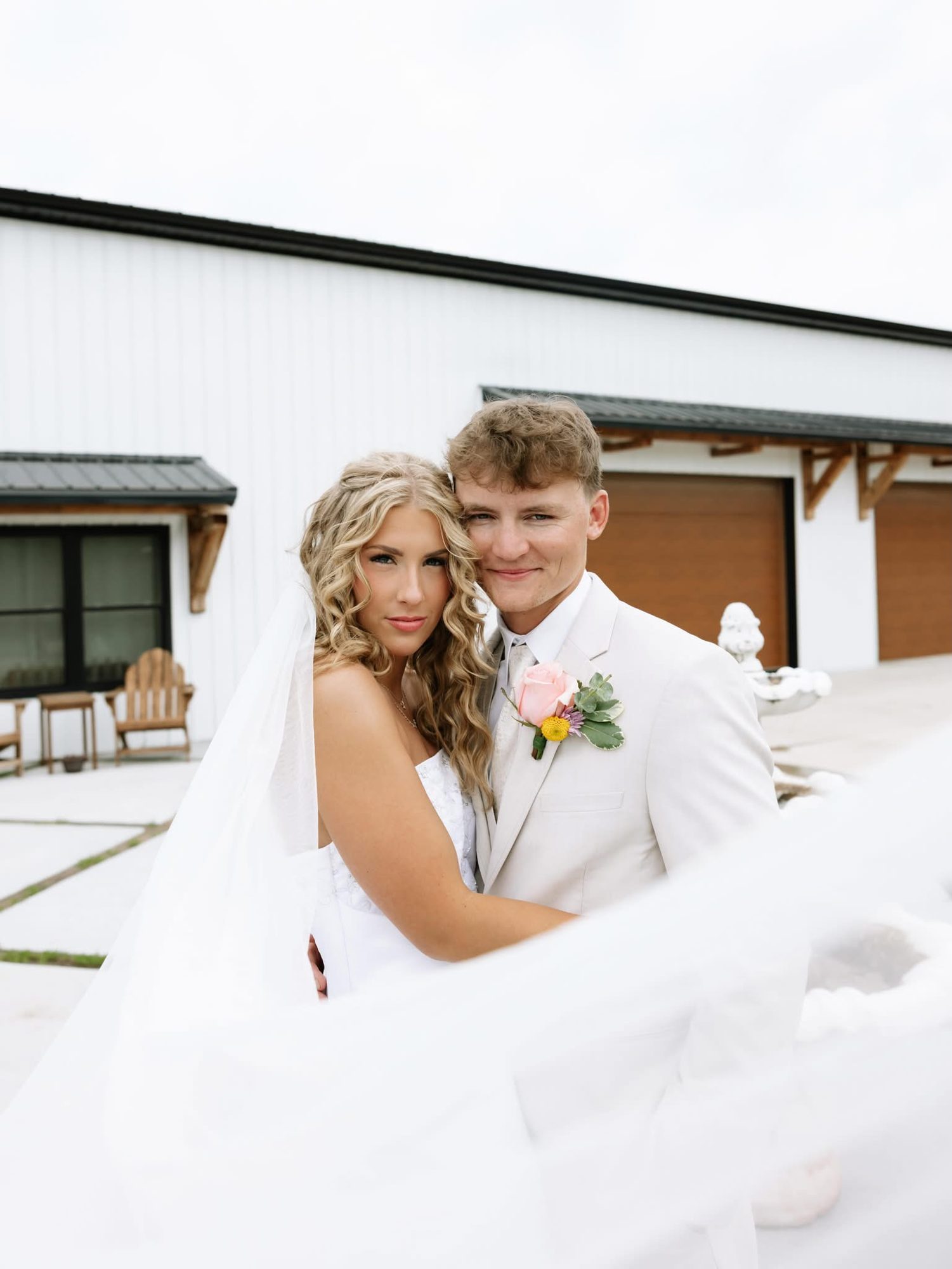 Couple with the bride's veil flowing